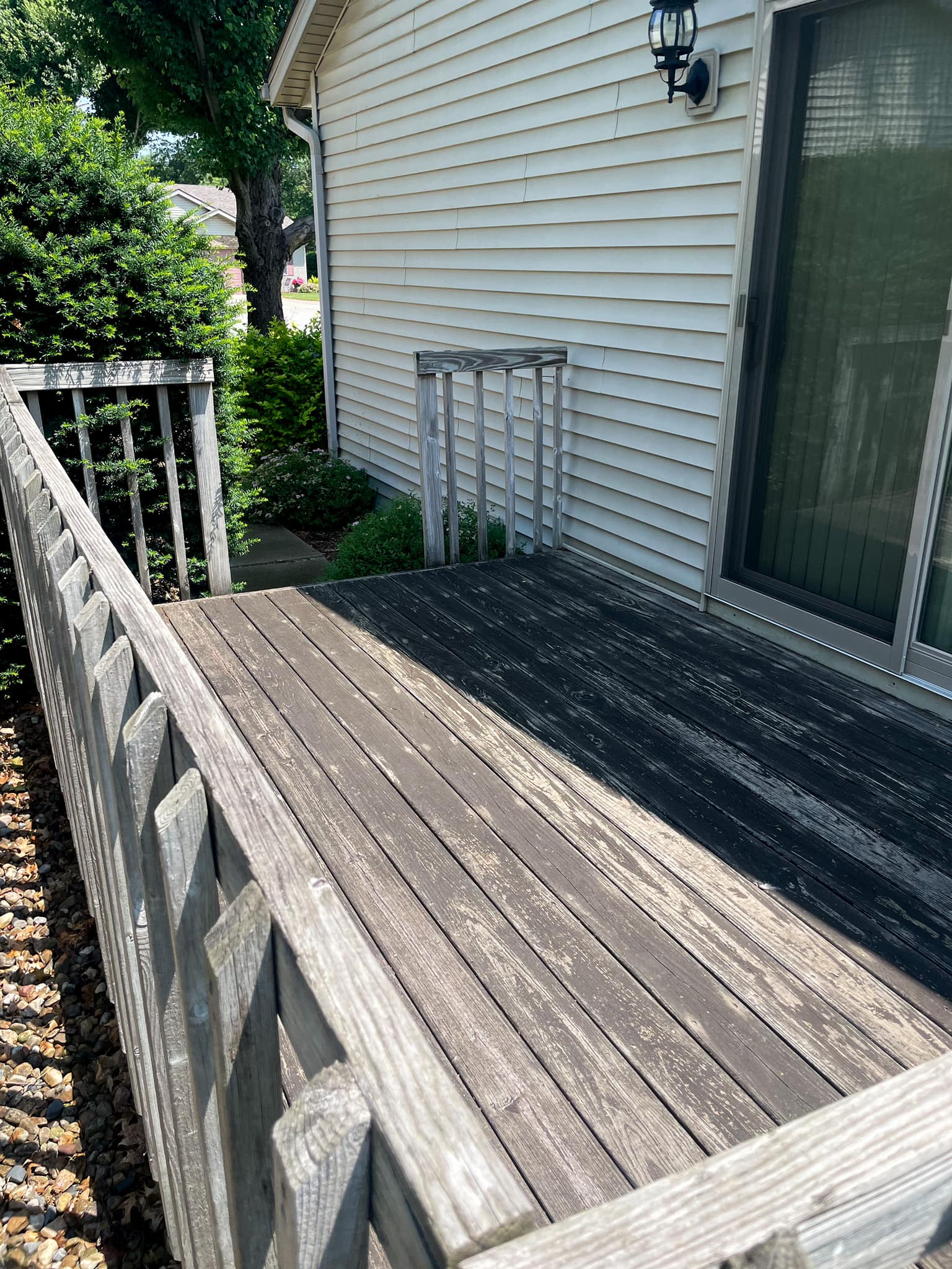 Deck before soft-wash cleaning in Champaign County, IL — grayed wood with algae and mildew buildup