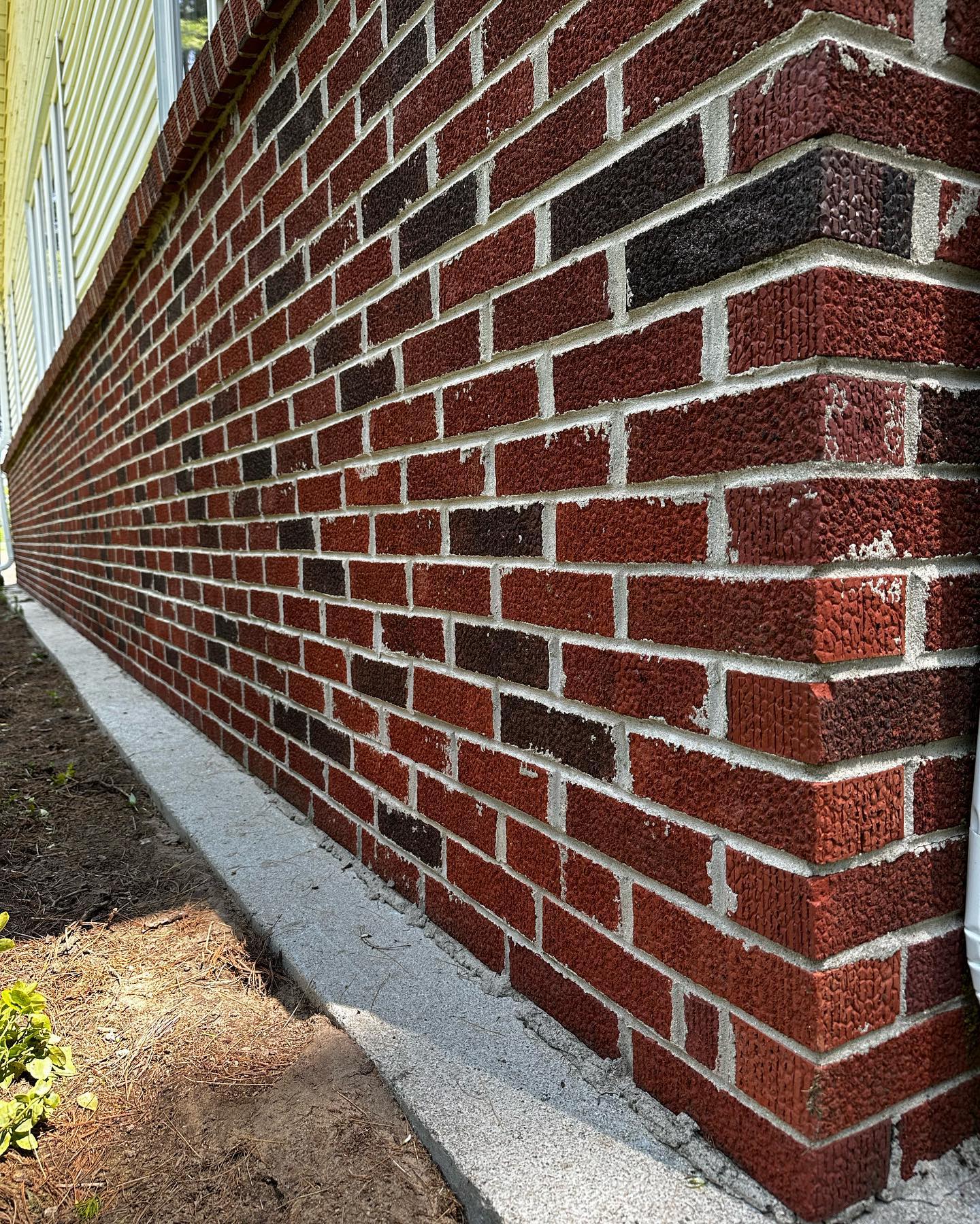 Freshly soft-washed brick exterior on a Champaign home — clean mortar lines and bright brick face